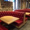 Tufted red leather booths at Duke University.